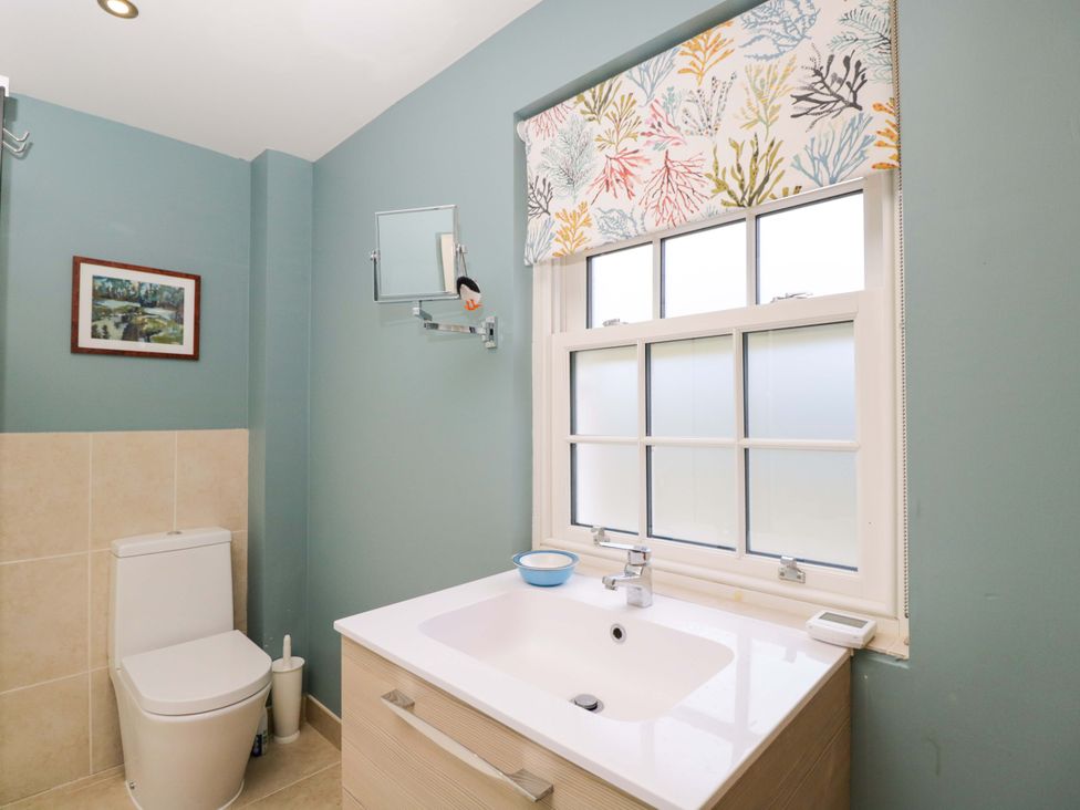 A bathroom with a toilet and vanity at Ormiston House in Netheravon