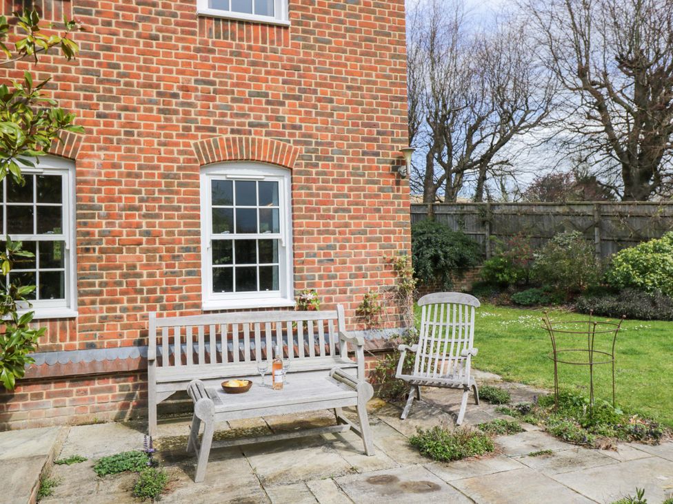 A garden area with a bench and chair at Ormiston House Netheravon