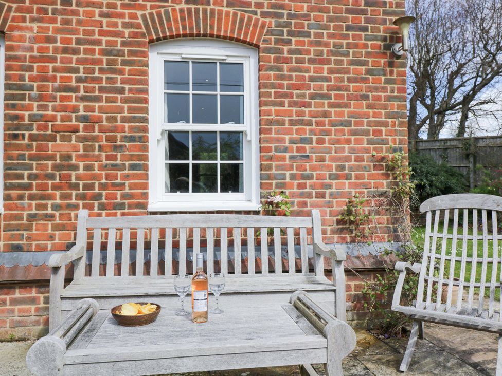 An outdoor seating area with a bench and snacks at Ormiston House, Netheravon