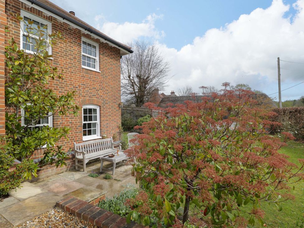 A garden with a bench and trees at Ormiston House in Netheravon