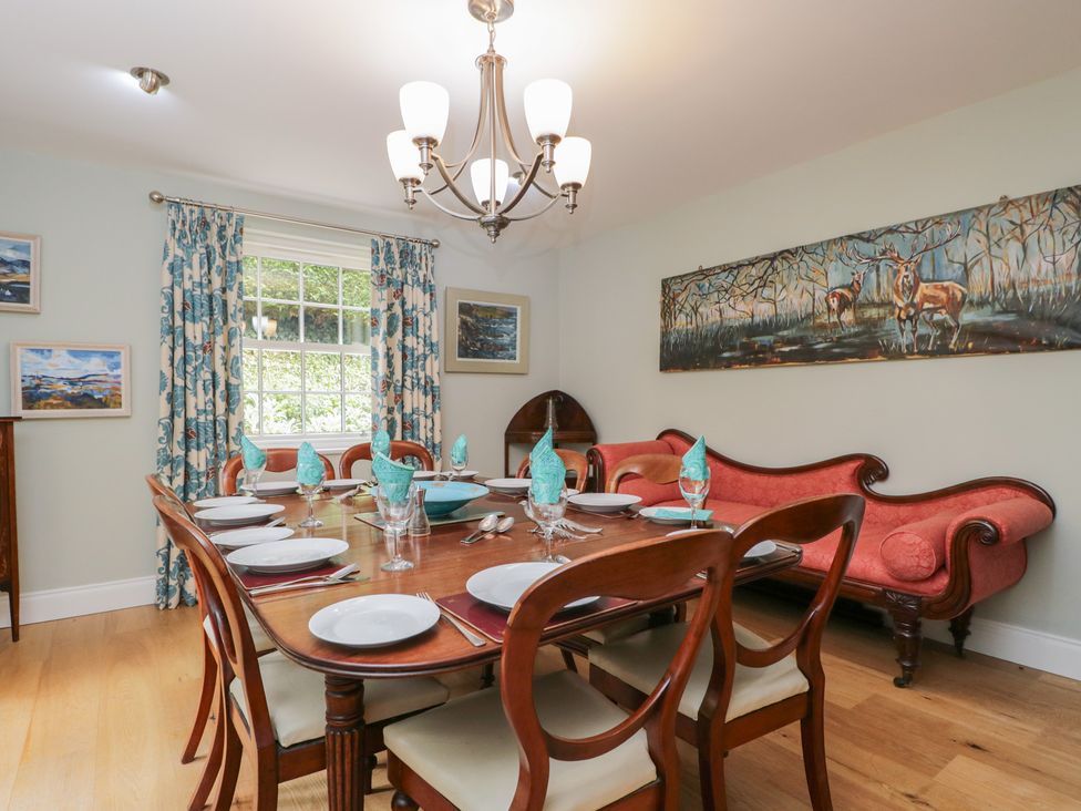A dining room with a table set for meals at Ormiston House in Enford near Netheravon