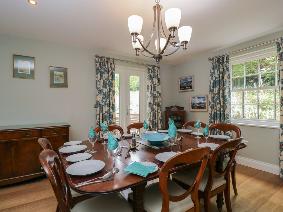A dining room with a table set for dinner at Ormiston House in Enford near Netheravon