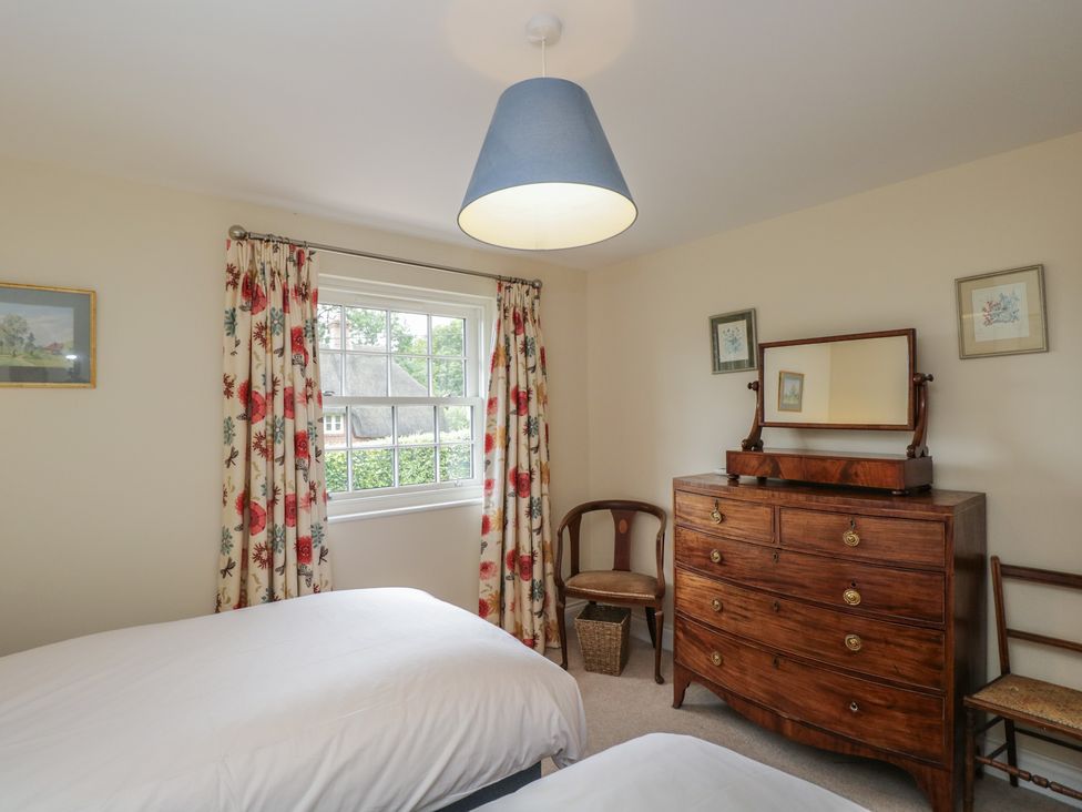 A bedroom with two beds and a dresser at Ormiston House in Enford near Netheravon