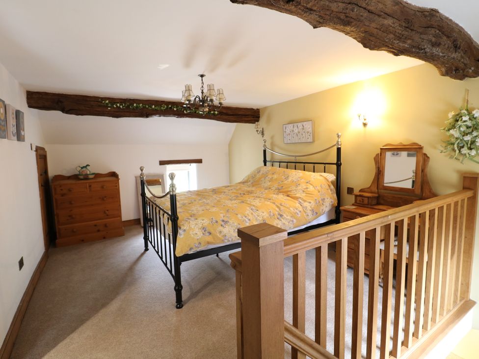 A bedroom with a bed and dresser at Orchard View Oakerthorpe