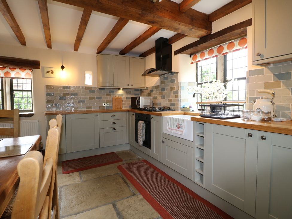 A kitchen with countertops and appliances at Orchard View in Oakerthorpe