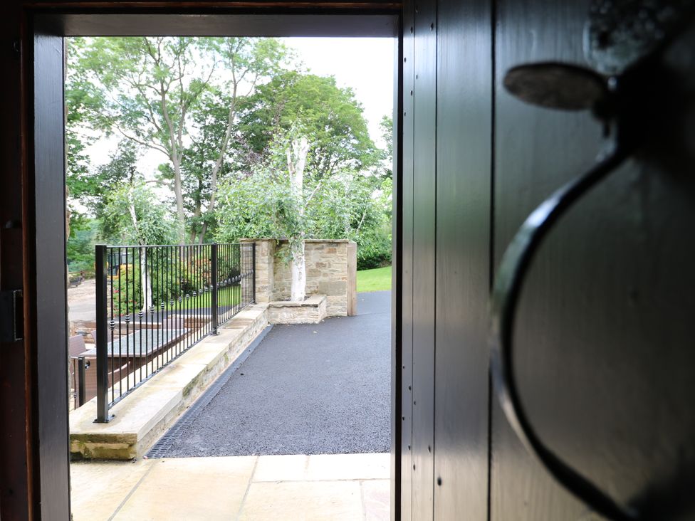 An outdoor entrance view with a pathway and trees at Orchard View Oakerthorpe