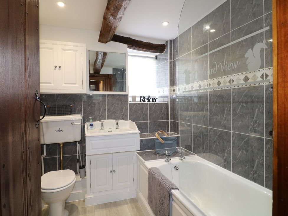 A bathroom featuring a bathtub and sink at Orchard View Oakerthorpe