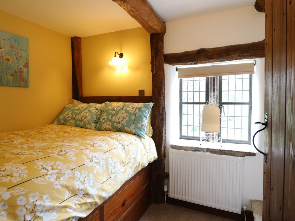 A bedroom with a bed and window at Orchard View in Oakerthorpe