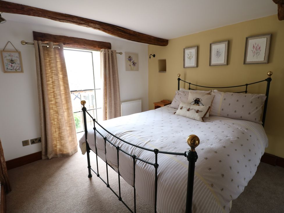A bedroom with a bed and window at Orchard View in Oakerthorpe