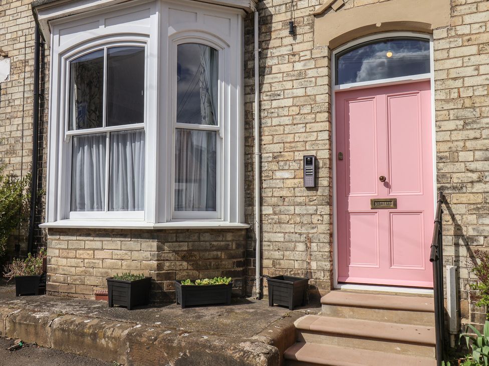 A house entrance with a pink door and a bay window at Nancy’s Blushes Saltburn-by-the-Sea