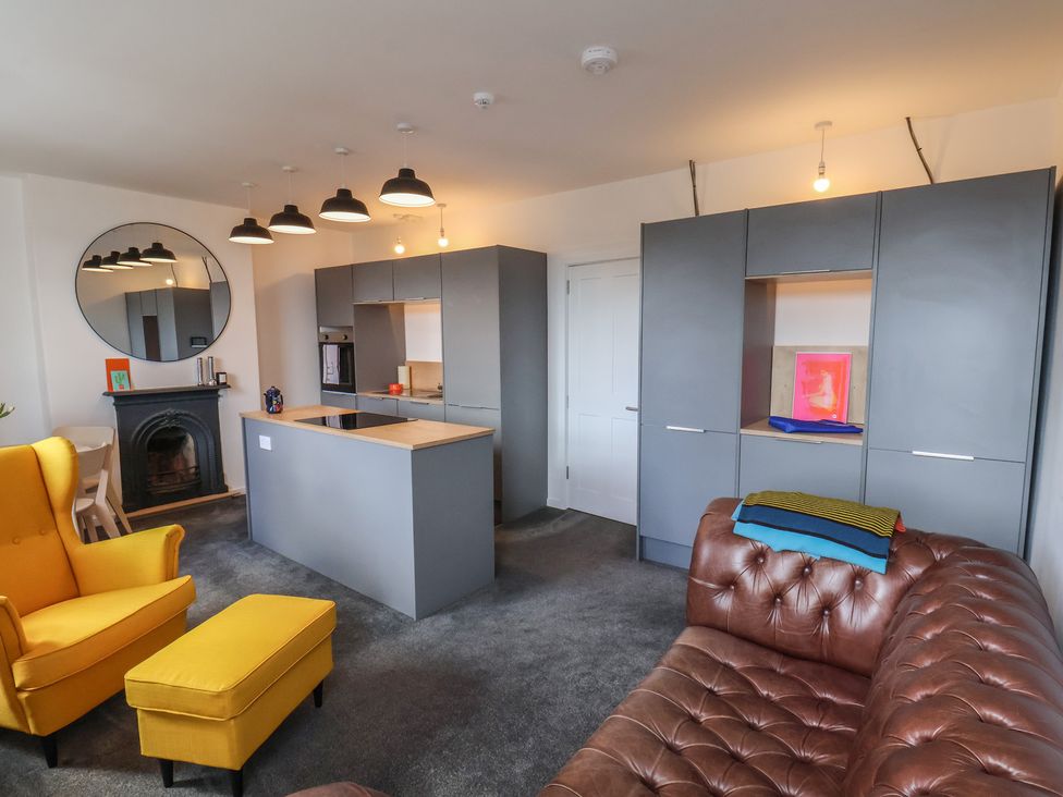 A living room with a kitchen island and sofa at Nancy’s Blushes Saltburn-by-the-Sea