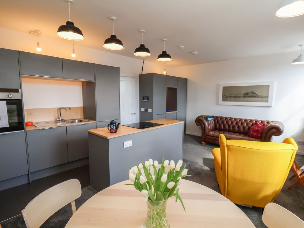 A kitchen with a sink and dining table at Nancy’s Blushes in Saltburn-by-the-Sea
