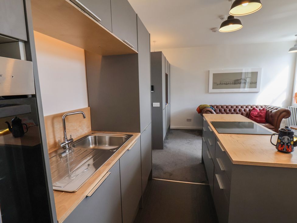 A kitchen with a sink and kitchen cabinets at Nancy’s Blushes in Saltburn-by-the-Sea