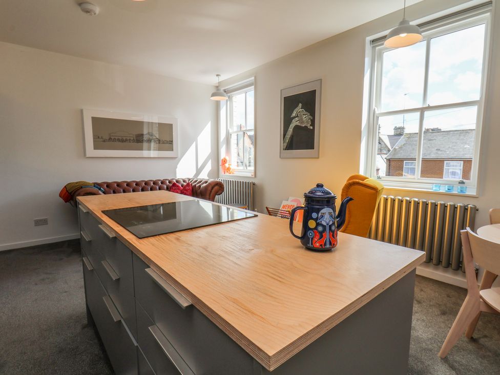 A kitchen with a stove on an island and a coffee pot at Nancy’s Blushes in Saltburn-by-the-Sea