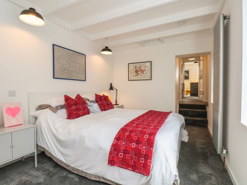 A bedroom with a bed and bedside table at Nancy’s Blushes Saltburn-by-the-Sea