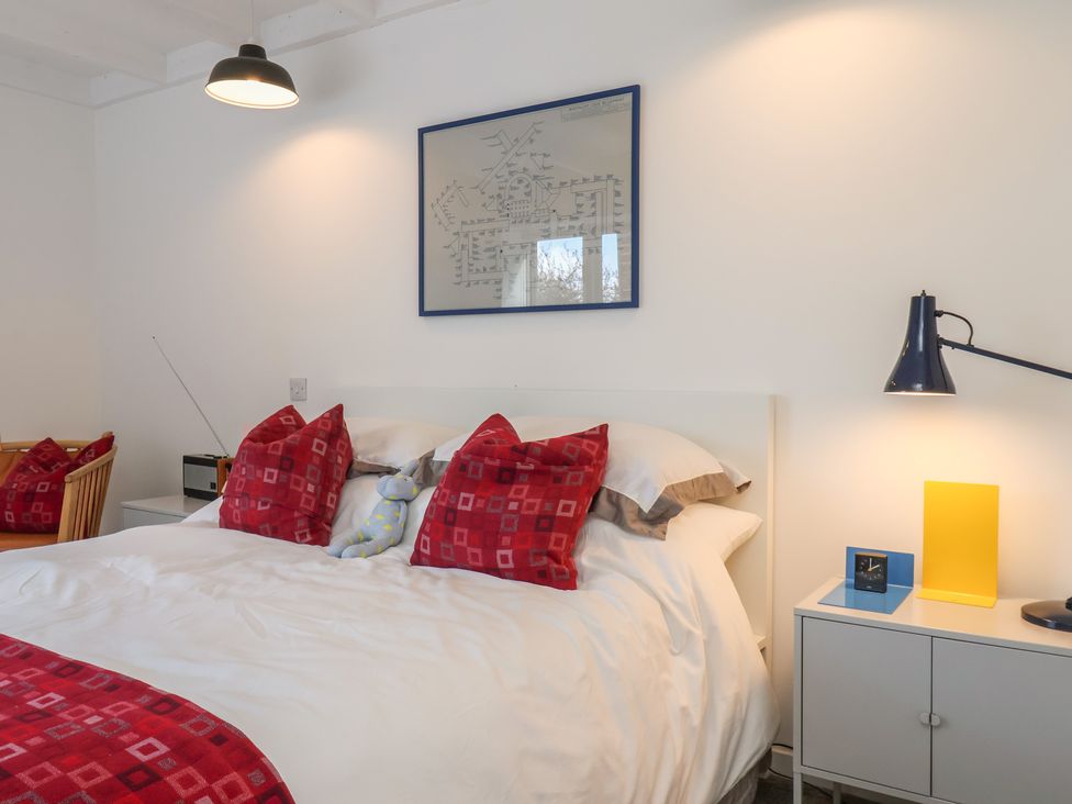 A bedroom with a bed and bedside table at Nancy’s Blushes in Saltburn-by-the-Sea
