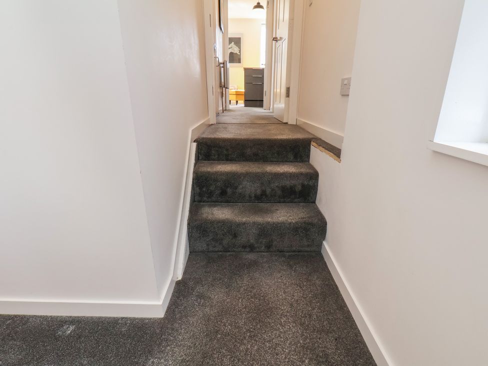 A hallway with stairs leading to another room at Nancy’s Blushes in Saltburn-by-the-Sea