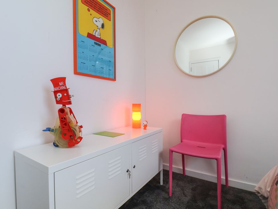 A bedroom with a calendar and toy on a storage cabinet at Nancy’s Blushes in Saltburn-by-the-Sea