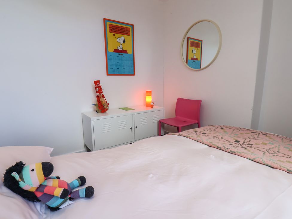 A bedroom with a bed and stuffed animal at Nancy’s Blushes in Saltburn-by-the-Sea