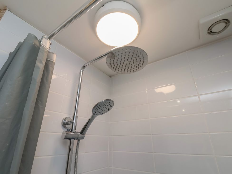 A shower with a showerhead and handheld shower at Nancy’s Blushes in Saltburn-by-the-Sea