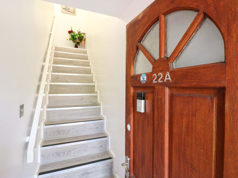 A hallway with a staircase and a door at 22A Warrender Road Tufnell Park