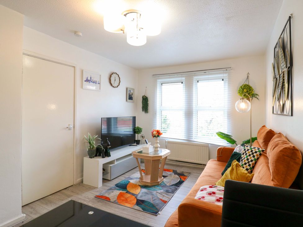 A living room with a sofa and television at 22A Warrender Road, Tufnell Park