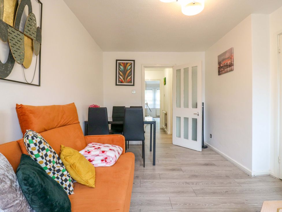 A living room with a sofa and dining area at 22A Warrender Road Tufnell Park