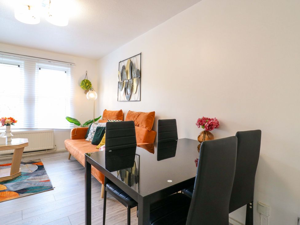 A living room with a sofa and dining table at 22A Warrender Road Tufnell Park