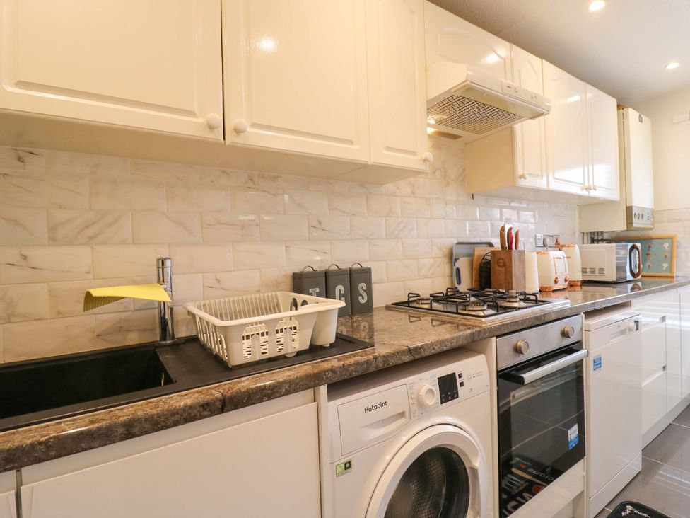 A kitchen with a sink and appliances at 22A Warrender Road Tufnell Park