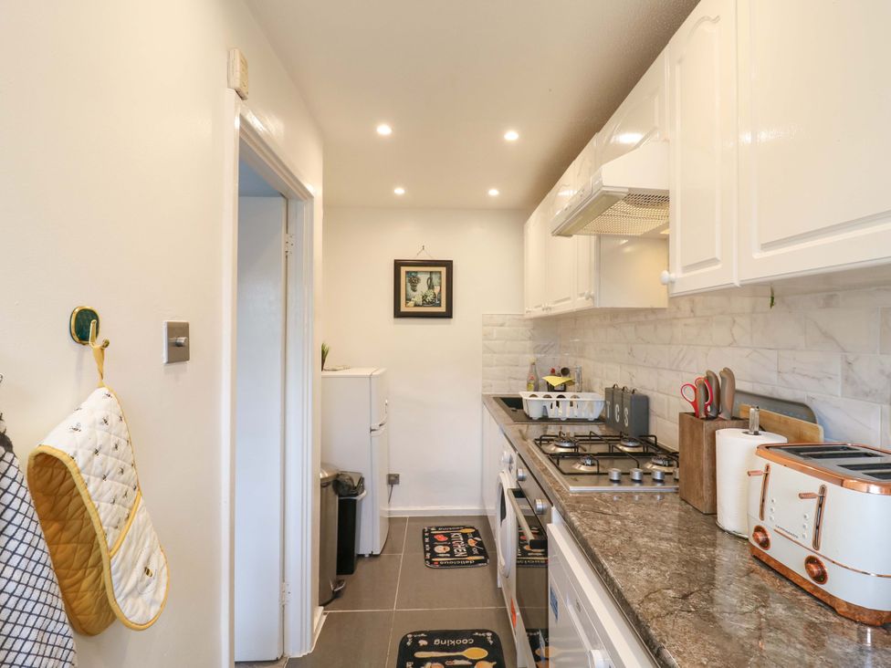 A kitchen with appliances and cooking utensils at 22A Warrender Road Tufnell Park