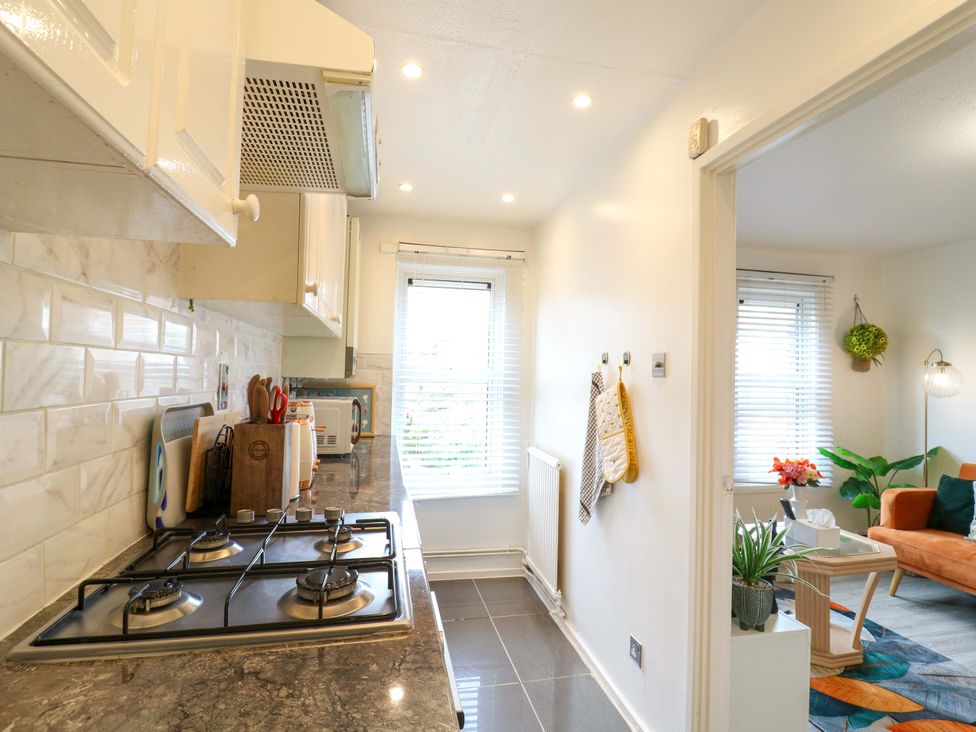 A kitchen with a gas stove and window at 22A Warrender Road Tufnell Park