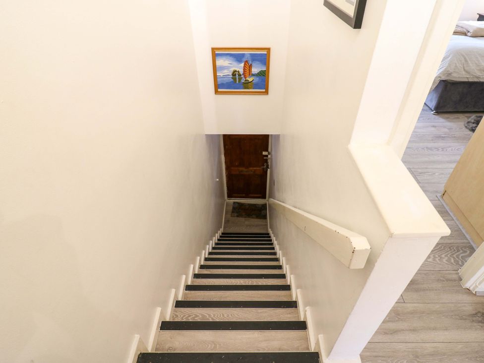 A staircase with a door and painting at 22A Warrender Road Tufnell Park