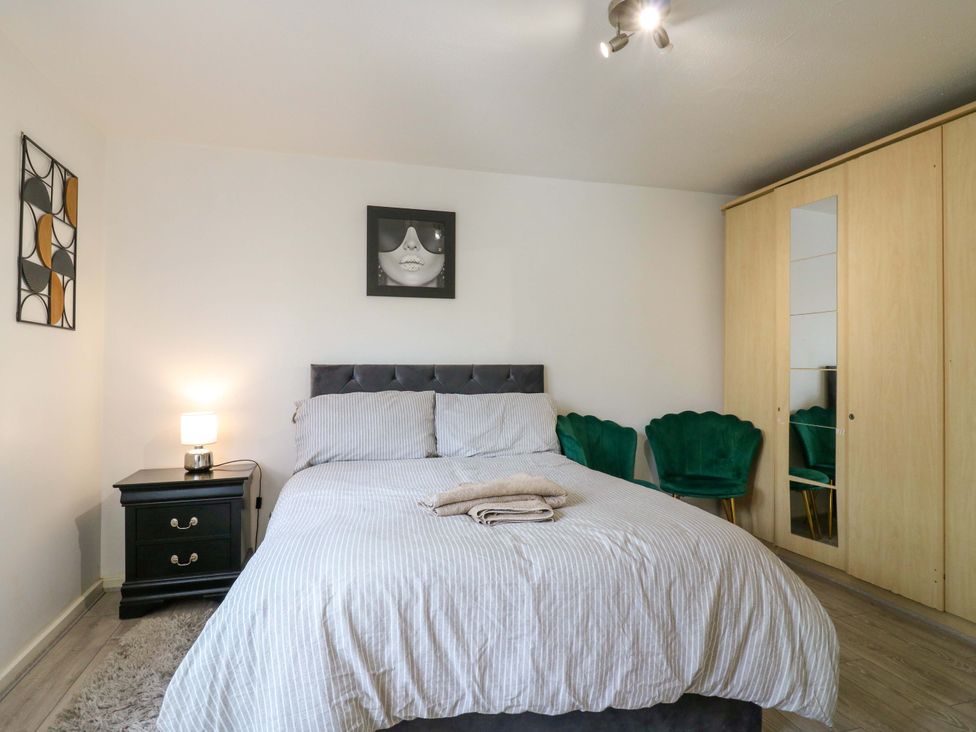 A bedroom with a bed and nightstand at 22A Warrender Road Tufnell Park