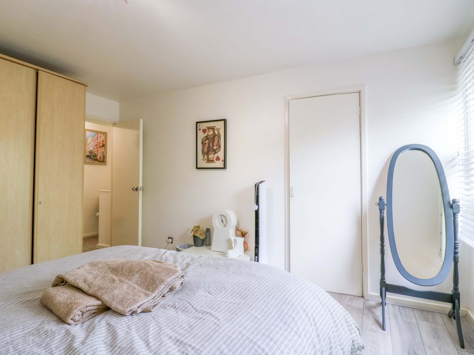A bedroom with a bed and wardrobe at 22A Warrender Road Tufnell Park