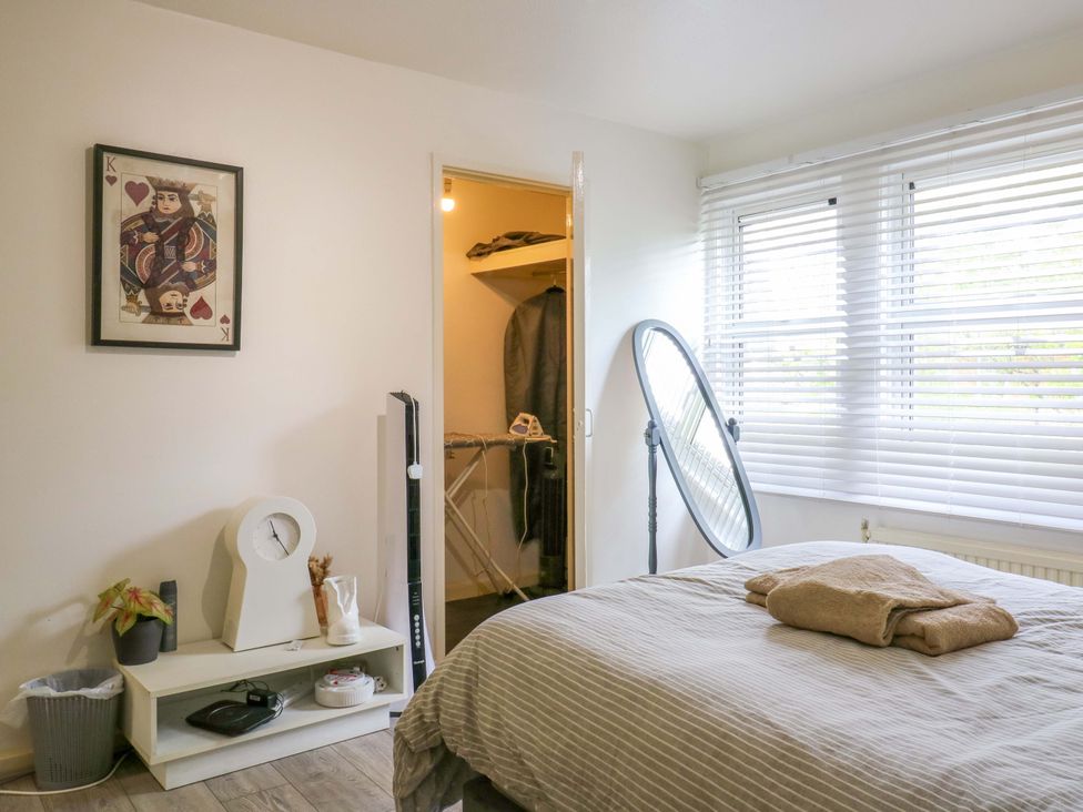 A bedroom with a bed and a mirror at 22A Warrender Road in Tufnell Park