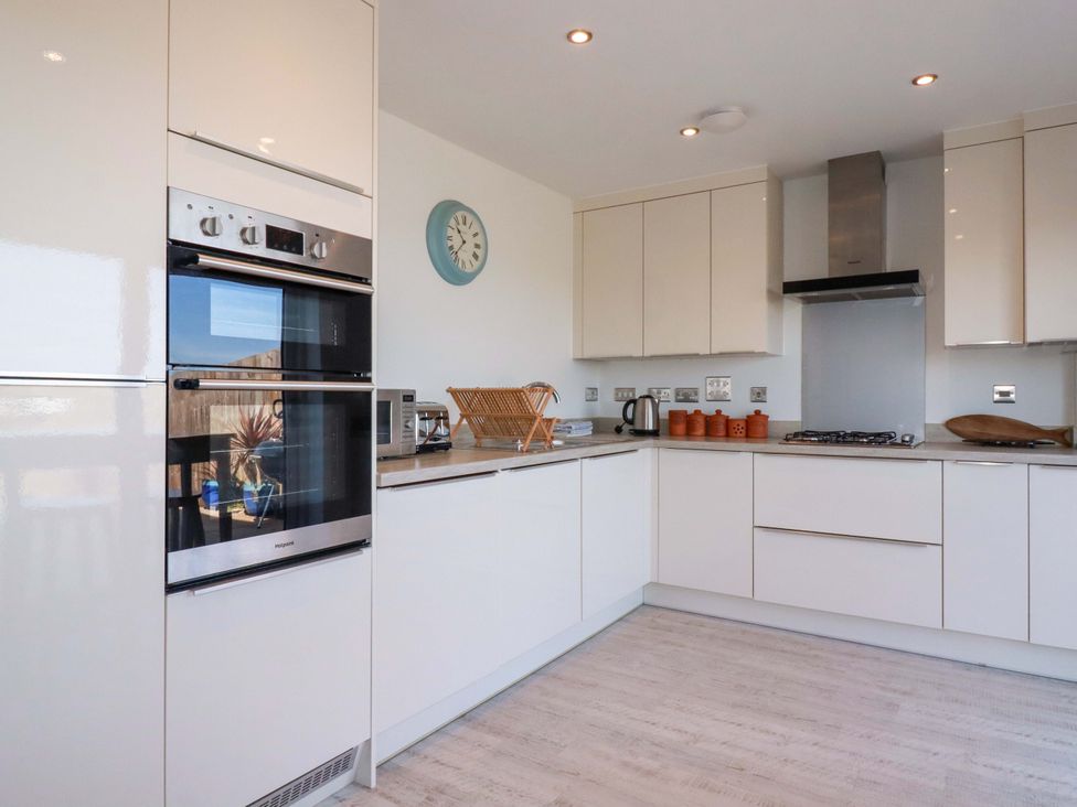 A kitchen with appliances and storage at Serfaus in Perranporth