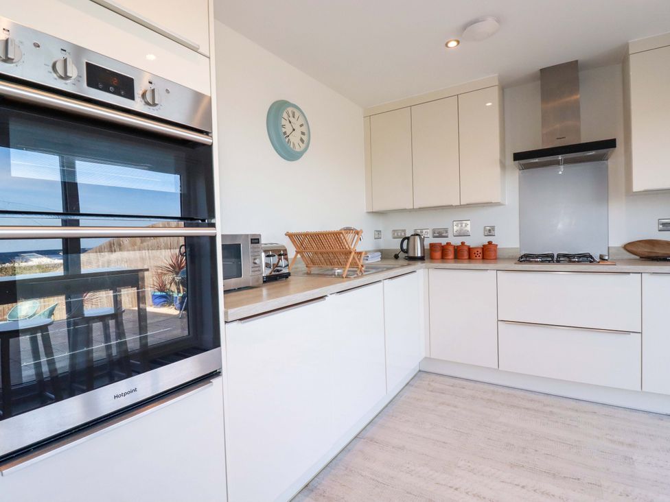 A kitchen with an oven, microwave, and stove at Serfaus in Perranporth