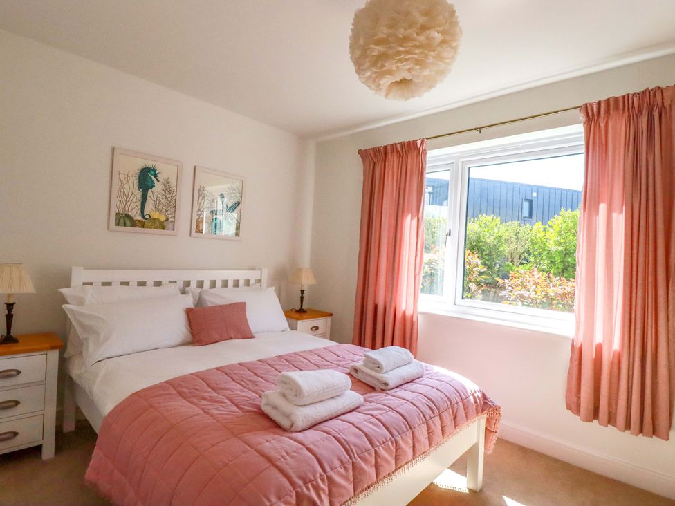 A bedroom with a bed and artwork at Serfaus in Perranporth
