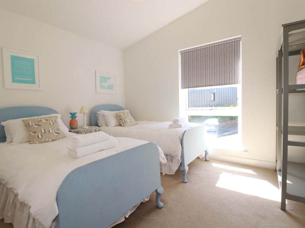 A bedroom with two beds and a window at Serfaus in Perranporth