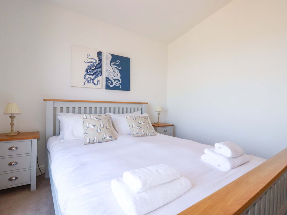 A bedroom with a bed and artwork at Serfaus in Perranporth