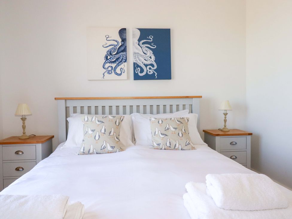 A bedroom with a bed and decorative pillows at Serfaus in Perranporth