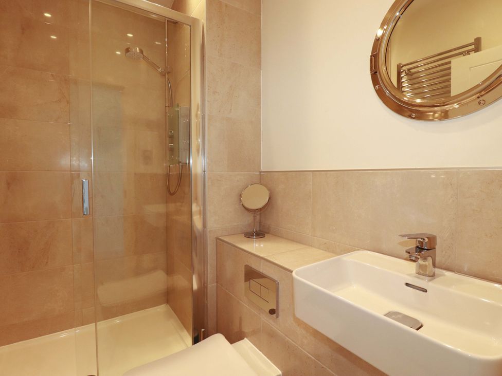 A bathroom with a shower and sink at Serfaus in Perranporth