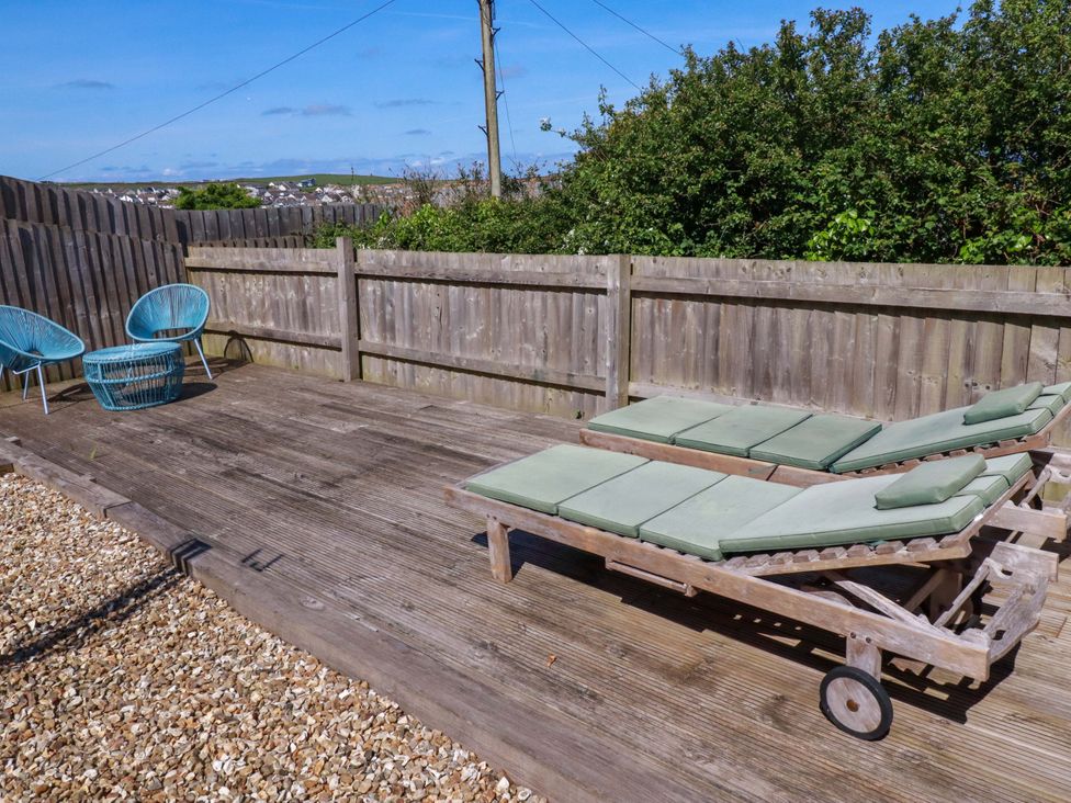 An outdoor space with sun loungers and chairs at Serfaus in Perranporth