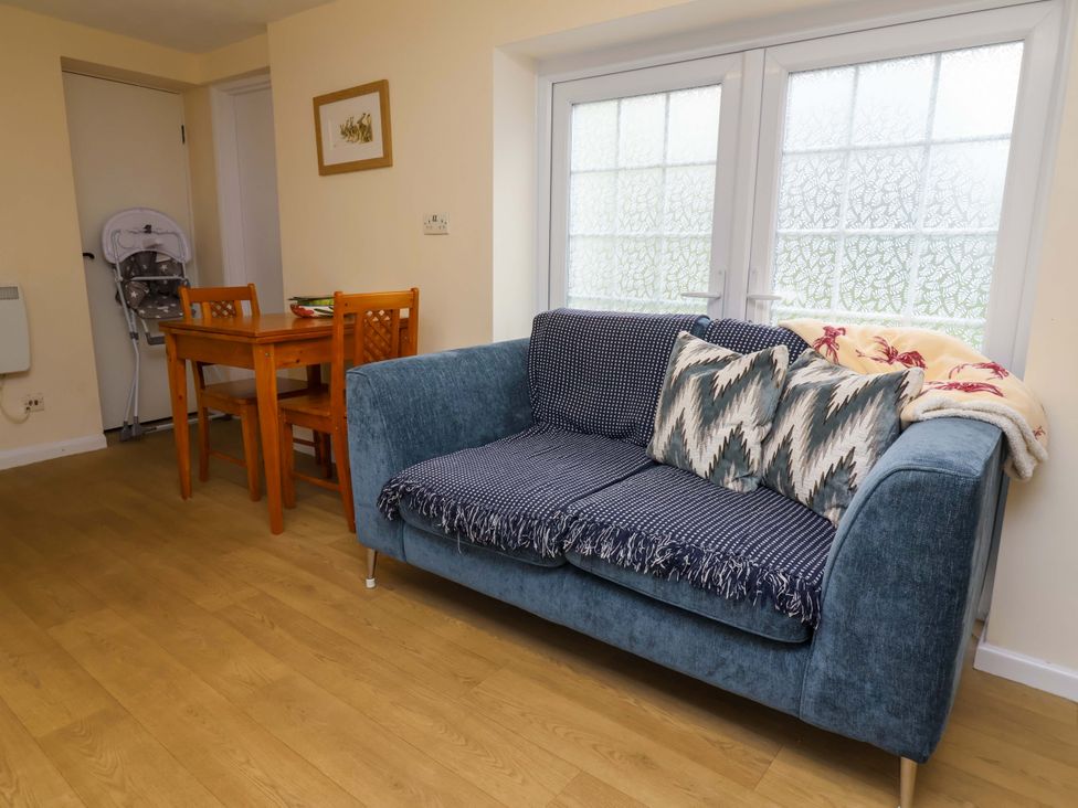 A living room with a sofa and dining table at The Apple Loft in Exeter