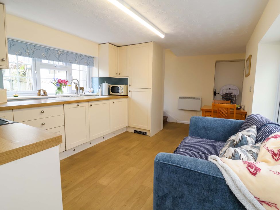A kitchen with a sofa and dining area at The Apple Loft in Exeter