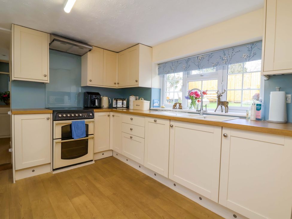 A kitchen with cabinets and cooking appliances at The Apple Loft in Exeter