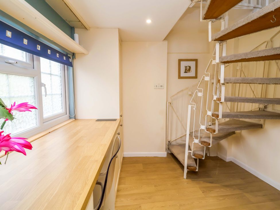 A kitchen with a countertop and staircase at The Apple Loft in Exeter