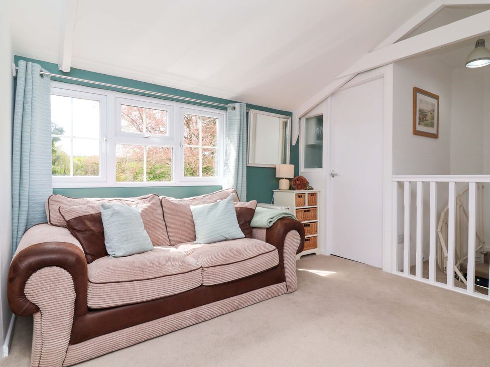 A snug with a sofa and windows at The Apple Loft in Exeter