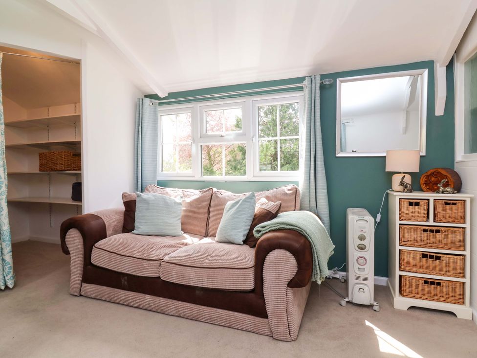 A living room with a sofa and a window at The Apple Loft in Exeter