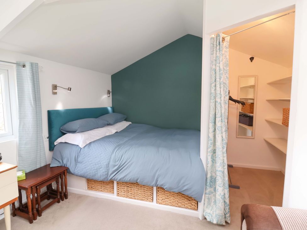 A bedroom with a bed and storage space at The Apple Loft in Exeter